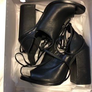 Unif heels - black leather ankle wrap. Chunky 90s feel.